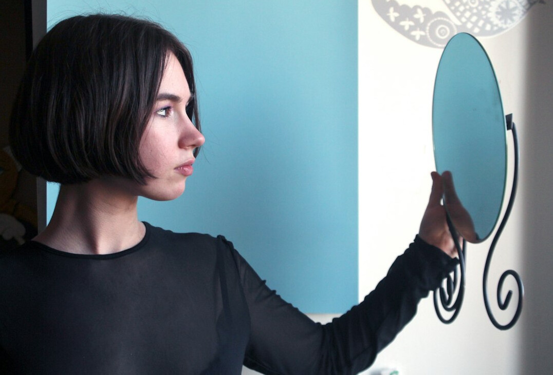 woman practicing speech in mirror